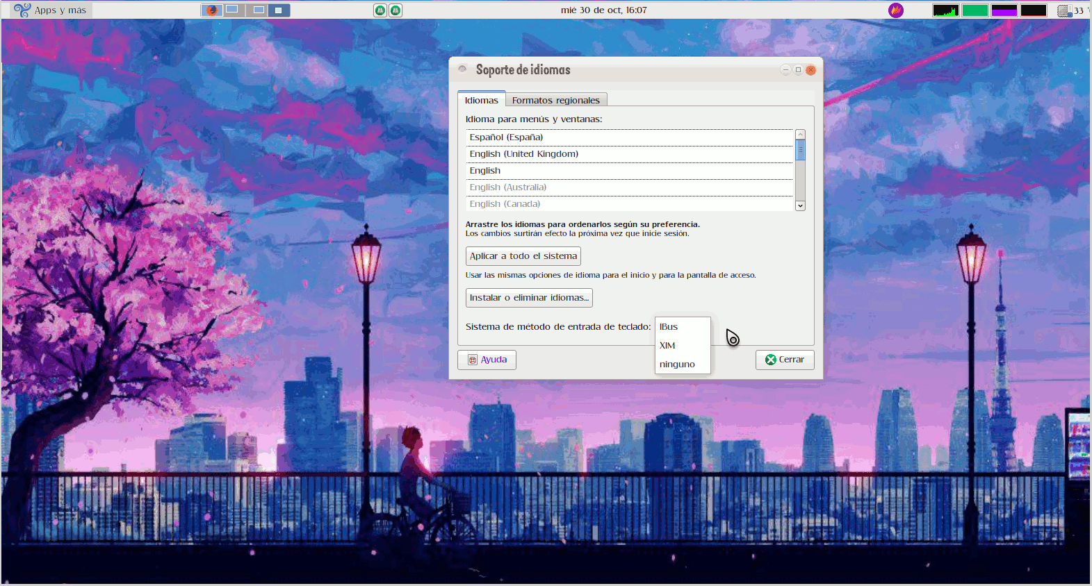 Imagen de un escritorio GNU/Linux con la ventana de configuración de idiomas y el desplegable con las opciones de método de entrada, entre las que se ve "ibus".